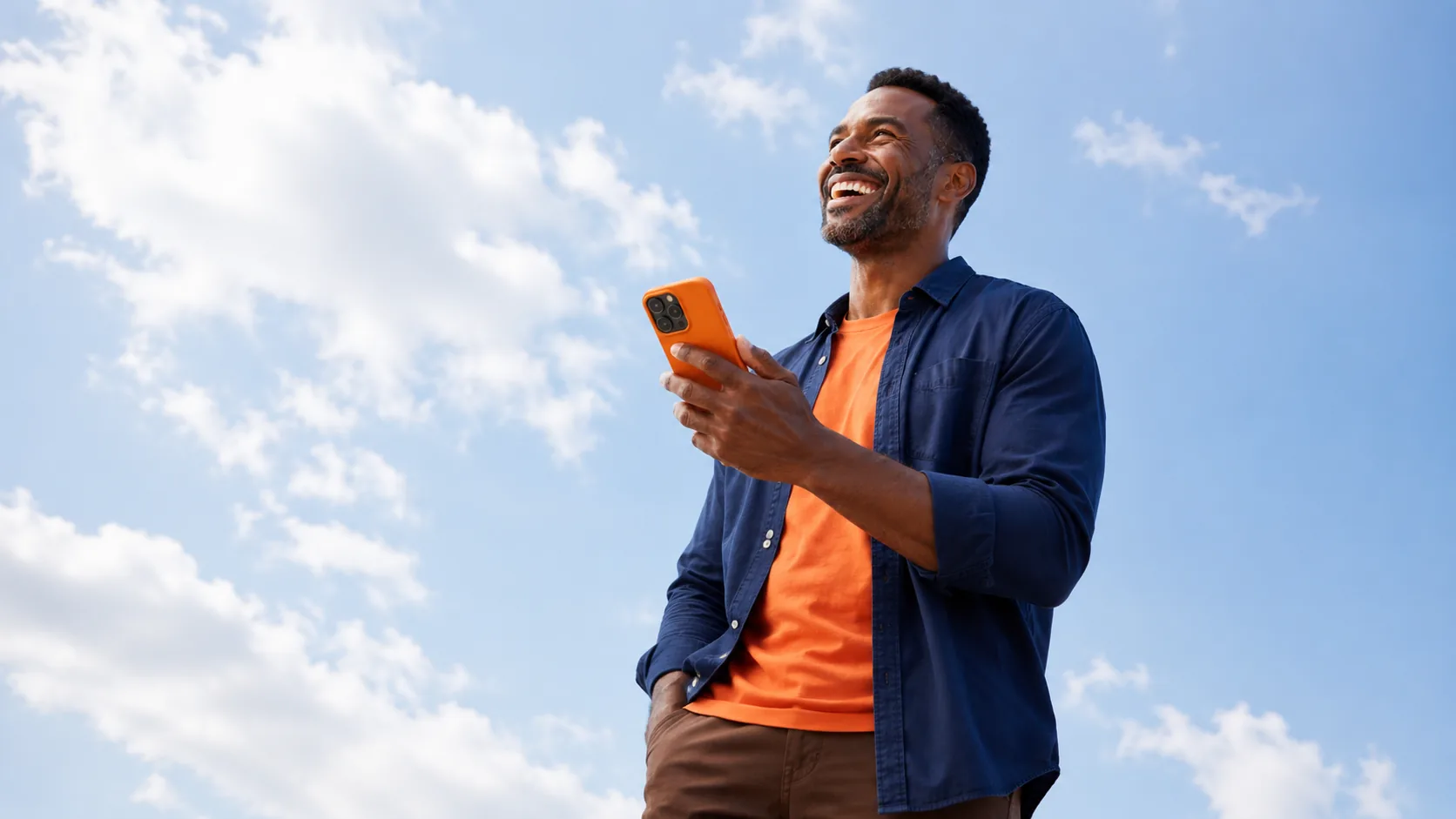 Homem sorrindo segurando o celular